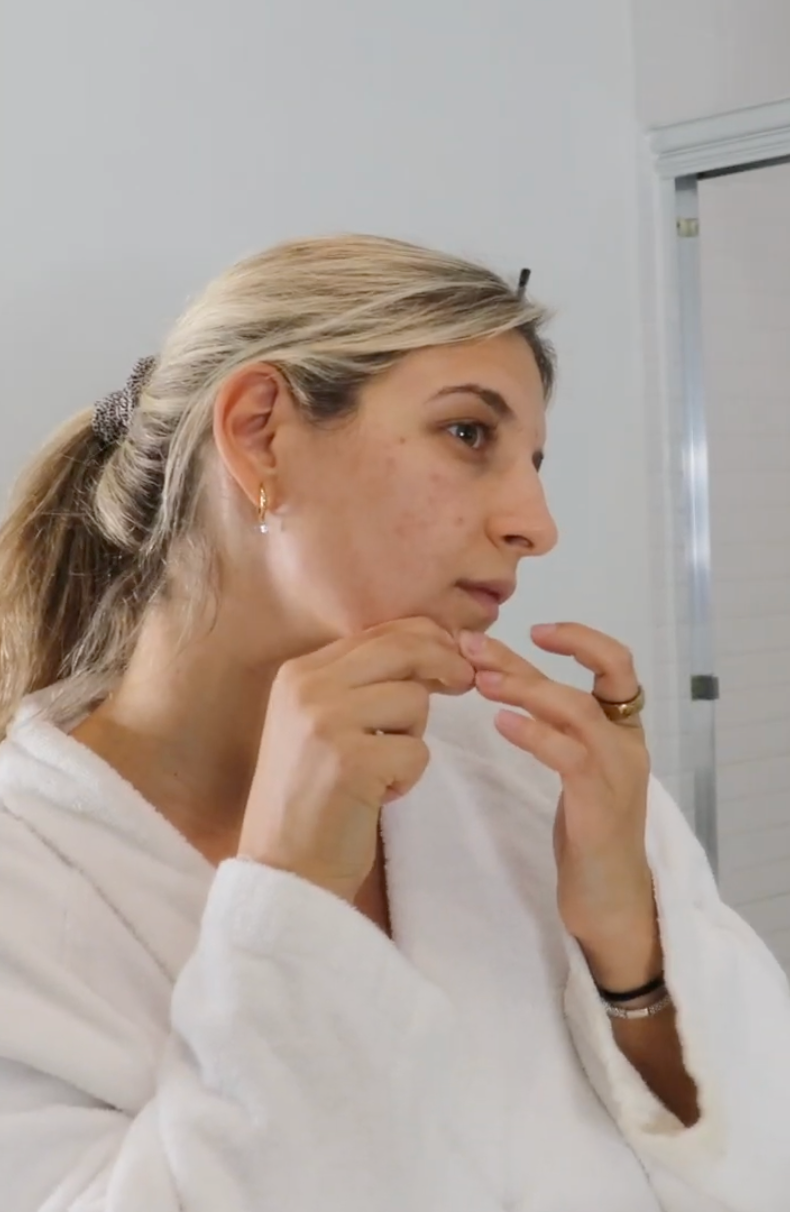 Jess, Eithio founder, picking her skin in a bathroom mirror — the vulnerable moment this brand was built around